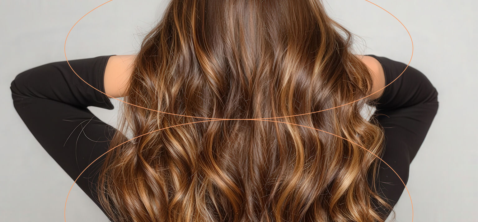 Cabelos ondulados castanho claro em destaque.