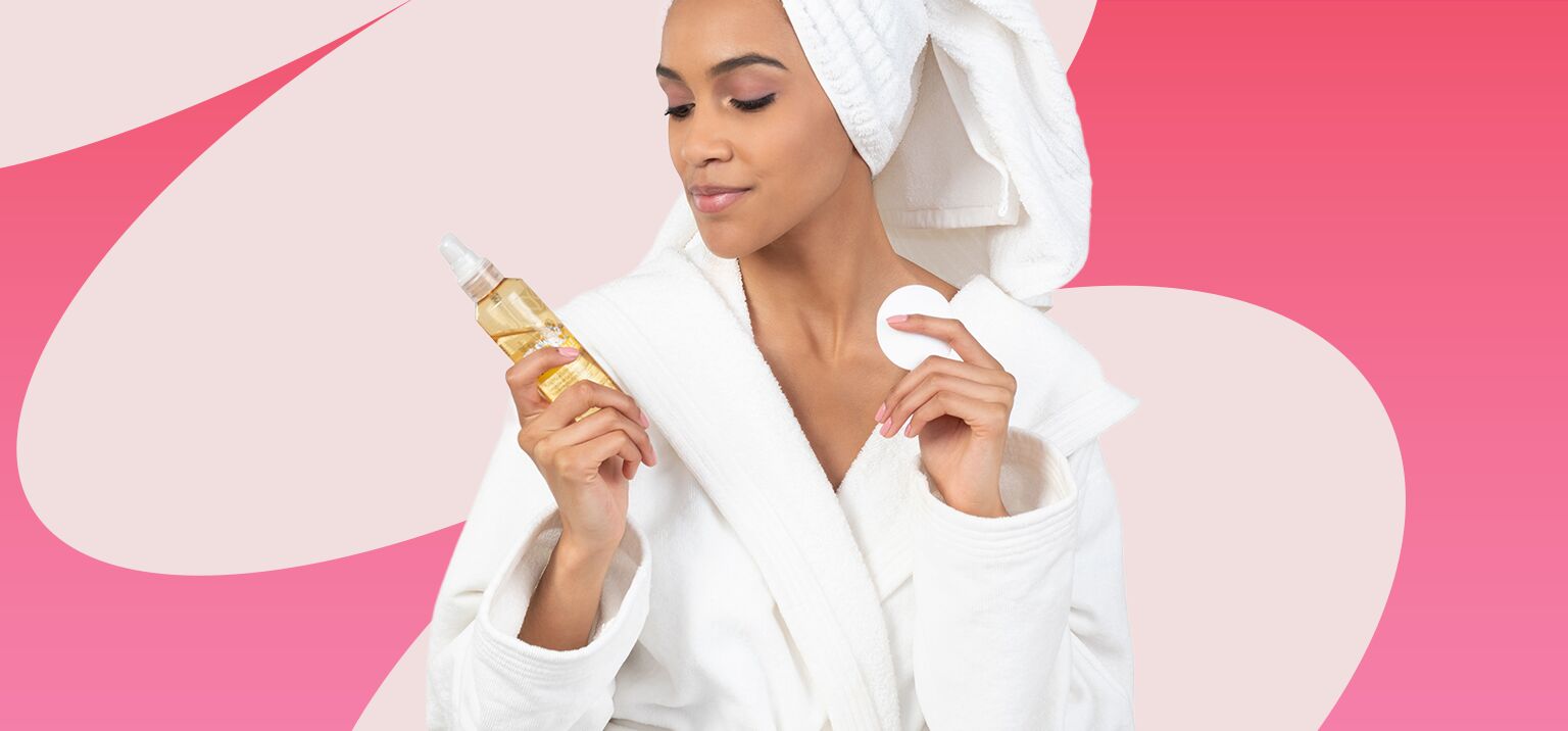 Mulher em robe com produto de skincare